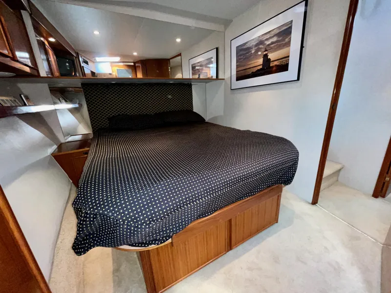 Slide: The Image of 1997 Post 50 Convertible yacht bedroom with polka dot bedding and framed artwork. - 19