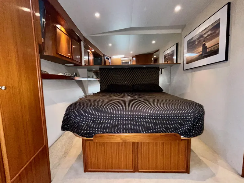 Slide: The Image of Luxurious cabin interior of a 1997 Post 50 Convertible yacht with elegant wood finishes. - 20