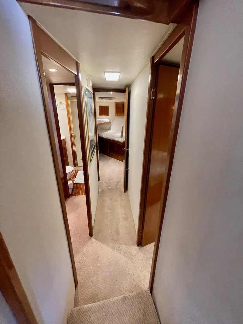 Slide: The Image of 1997 Post 50 Convertible yacht interior hallway with carpet and wooden trim. - 22