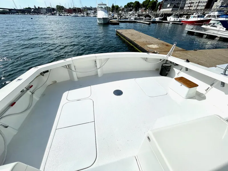 Slide: The Image of 1997 Post 50 Convertible boat deck at marina with water and dock view. - 31