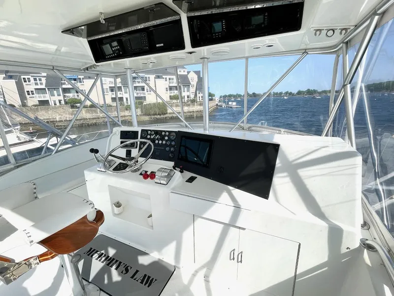 Slide: The Image of 1997 Post 50 Convertible yacht helm with modern controls, overlooking marina and waterfront buildings. - 33