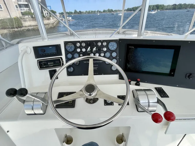 Slide: The Image of Control panel of a 1997 Post 50 Convertible boat with steering wheel and navigation instruments. - 35