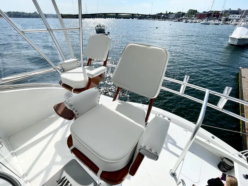 Slide: The Image of 1997 Post 50 Convertible yacht with white seats overlooking a serene marina. - 36
