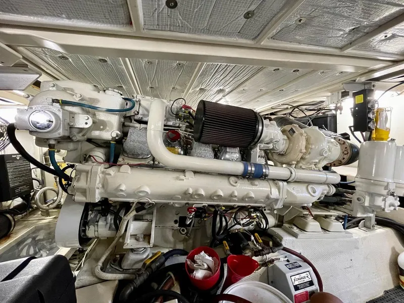 Slide: The Image of Engine room of a 1997 Post 50 Convertible yacht, showcasing detailed machinery and components. - 38