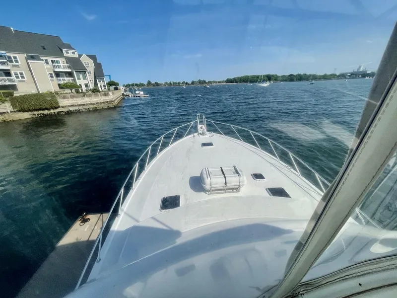 Slide: The Image of 1997 Post 50 Convertible yacht on calm waters near residential area. - 41