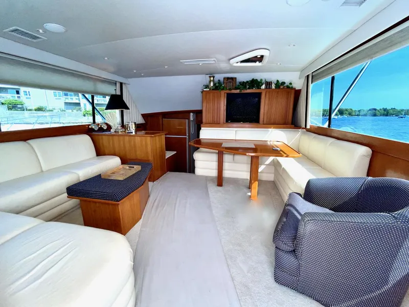Slide: The Image of Luxurious interior of a 1997 Post 50 Convertible yacht with elegant seating and panoramic windows. - 5