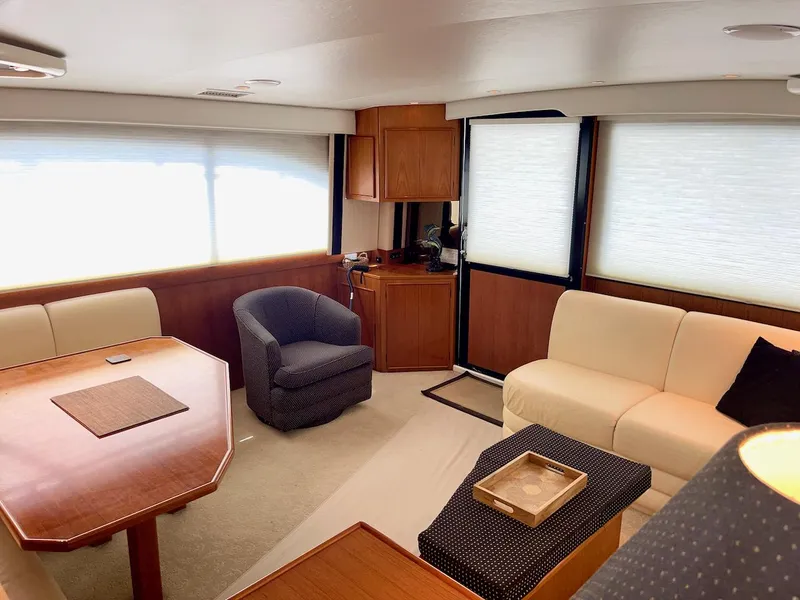 Slide: The Image of Luxurious interior of a 1997 Post 50 Convertible yacht with elegant seating and wooden accents. - 8