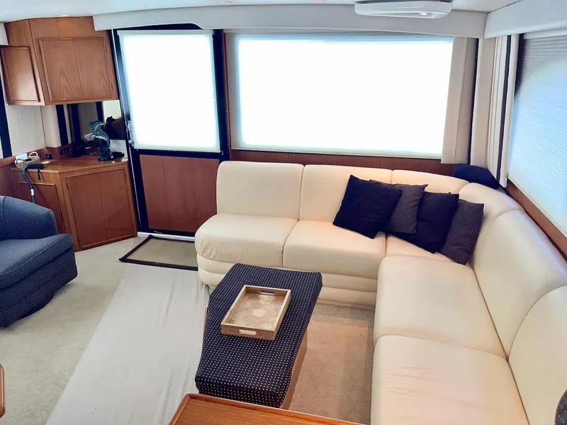 Slide: The Image of Luxurious interior of a 1997 Post 50 Convertible yacht with cream sofa and navy accents. - 9