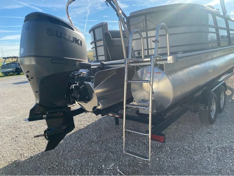 Slide: The Image of 2025 Trifecta C Series 24RFC pontoon boat with Suzuki outboard motor and ladder. - 15