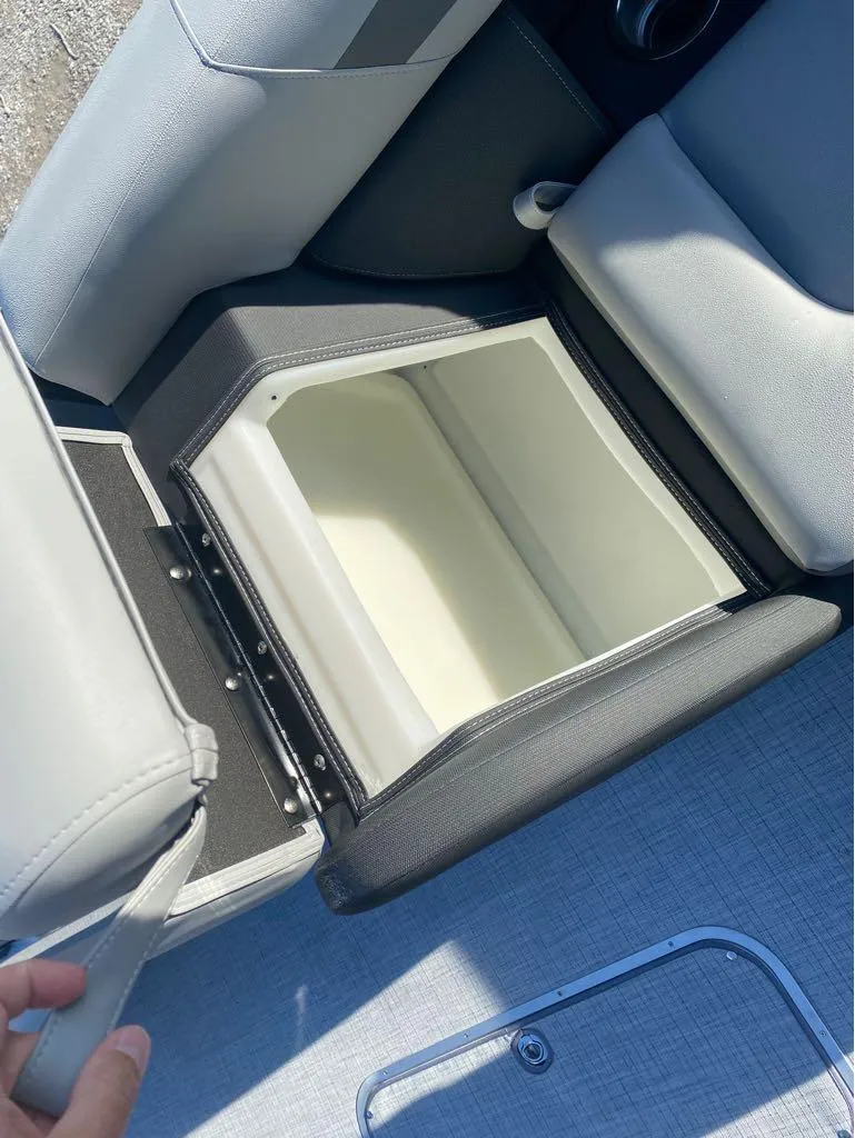 Slide: The Image of Open storage compartment in 2025 Trifecta C Series 24RFC boat seat. - 18
