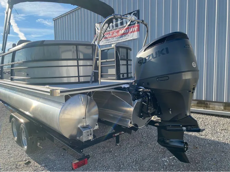 Slide: The Image of 2025 Trifecta C Series 24RFC pontoon boat with Suzuki outboard motor on trailer. - 20