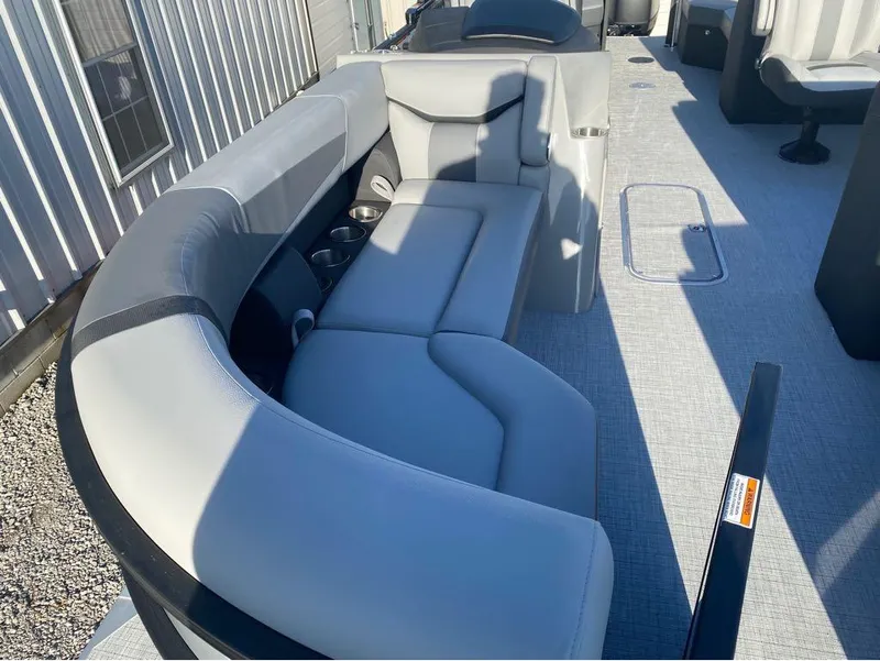 Slide: The Image of 2025 Trifecta C Series 24RFC pontoon boat with gray seating and modern interior design. - 8