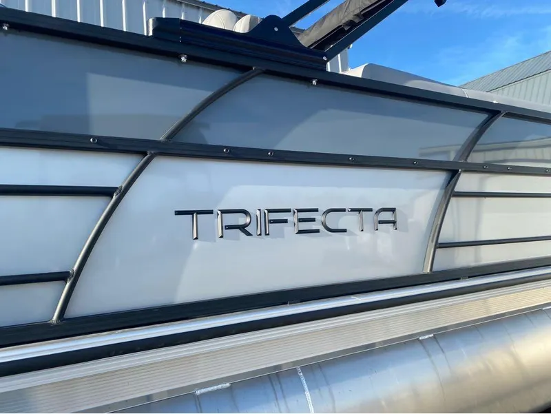 Slide: The Image of 2025 Trifecta C Series 24RFC pontoon boat with sleek design and branding. - 9