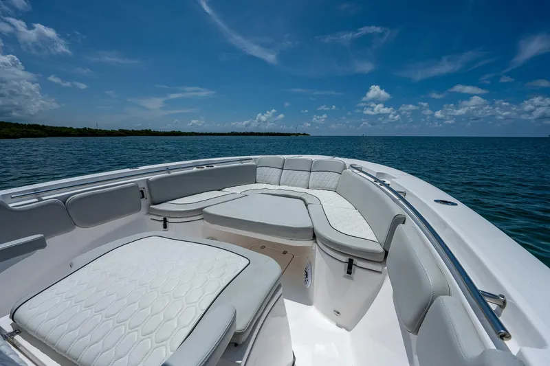 Slide: The Image of 2022 Sea Fox 288 Commander boat interior with white seating, ocean view, and blue sky. - 10