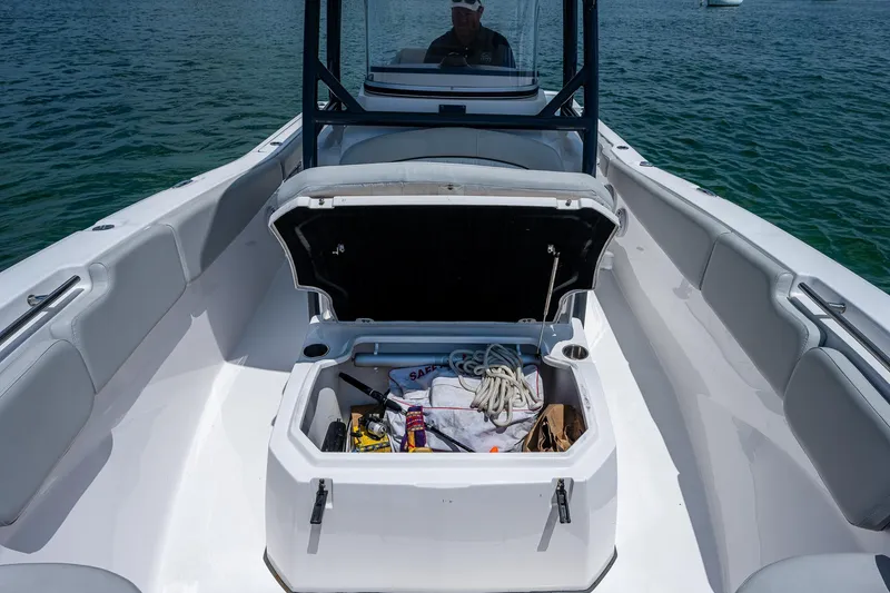 Slide: The Image of 2022 Sea Fox 288 Commander boat with open storage compartment, docked on water. - 16