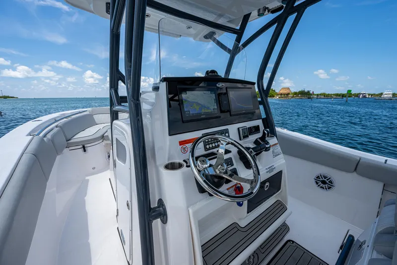 Slide: The Image of 2022 Sea Fox 288 Commander boat interior with steering console, on a sunny day at sea. - 19