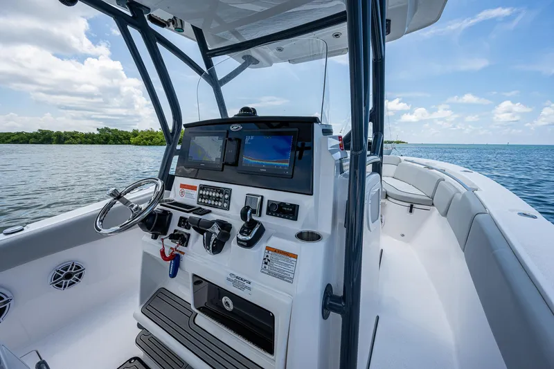 Slide: The Image of 2022 Sea Fox 288 Commander boat helm with modern controls on a sunny day. - 20