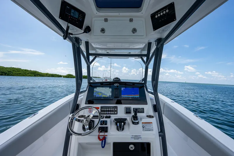 Slide: The Image of 2022 Sea Fox 288 Commander boat dashboard with navigation screens on open water. - 21