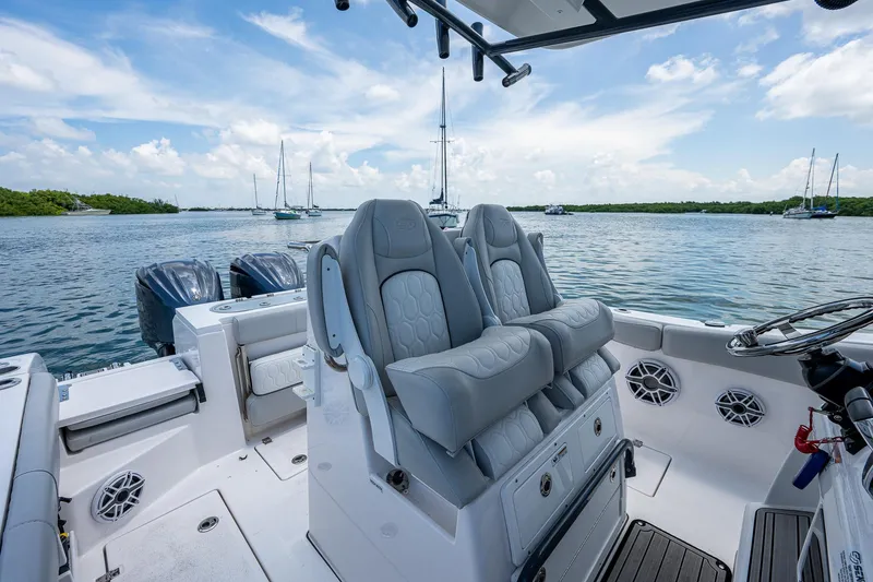 Slide: The Image of 2022 Sea Fox 288 Commander boat interior with dual seats, ocean view, and clear sky. - 22