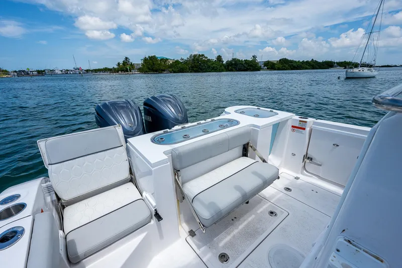 Slide: The Image of 2022 Sea Fox 288 Commander boat with dual engines, white seating, and scenic water view. - 24