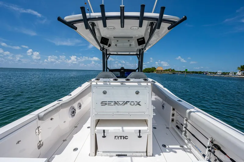 Slide: The Image of 2022 Sea Fox 288 Commander boat on water, featuring spacious deck and RTIC cooler. - 26