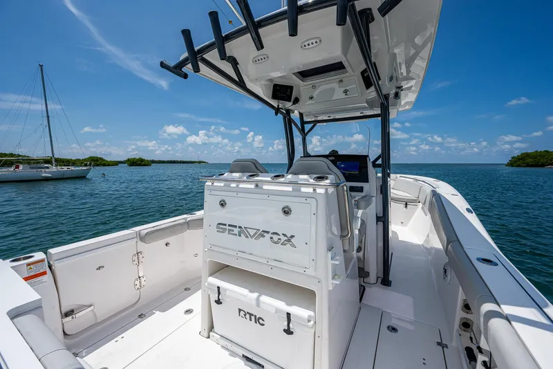 Slide: The Image of 2022 Sea Fox 288 Commander boat on water, featuring spacious deck and modern console. - 28