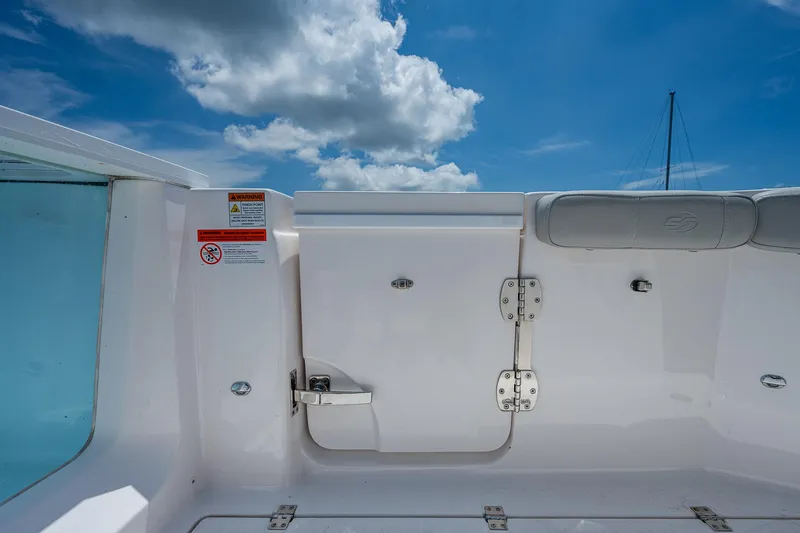 Slide: The Image of 2022 Sea Fox 288 Commander boat interior with white seating and blue sky background. - 29