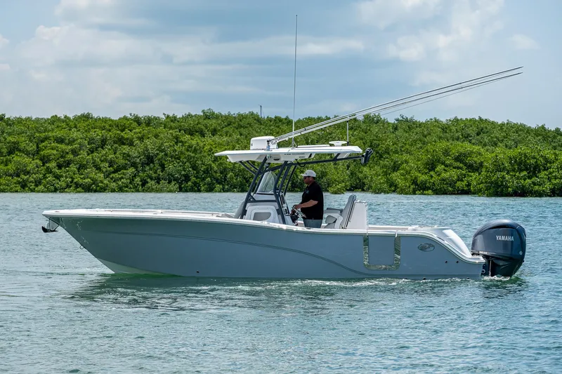 Slide: The Image of 2022 Sea Fox 288 Commander boat on water, with lush greenery in the background. - 4