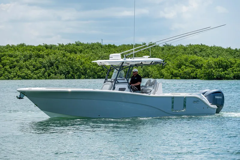 Slide: The Image of 2022 Sea Fox 288 Commander boat cruising on calm water with lush greenery in the background. - 5