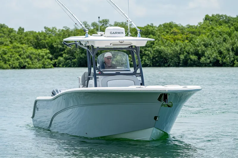 Slide: The Image of 2022 Sea Fox 288 Commander boat cruising on a calm lake with lush greenery. - 7