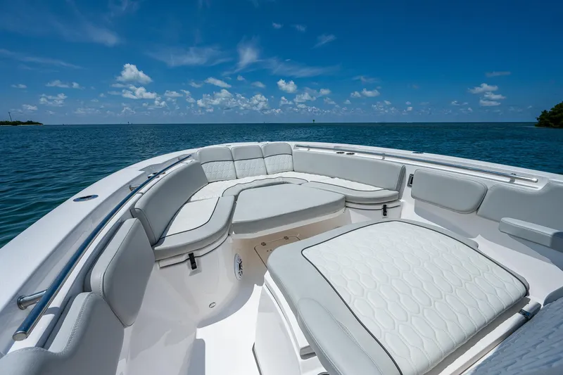 Slide: The Image of 2022 Sea Fox 288 Commander boat interior with white seating, ocean view, and blue sky. - 9