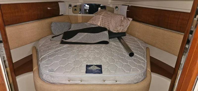 Slide: The Image of 2005 Sea Ray 360 Sundancer cabin with bed, pillows, and accessories. - 11