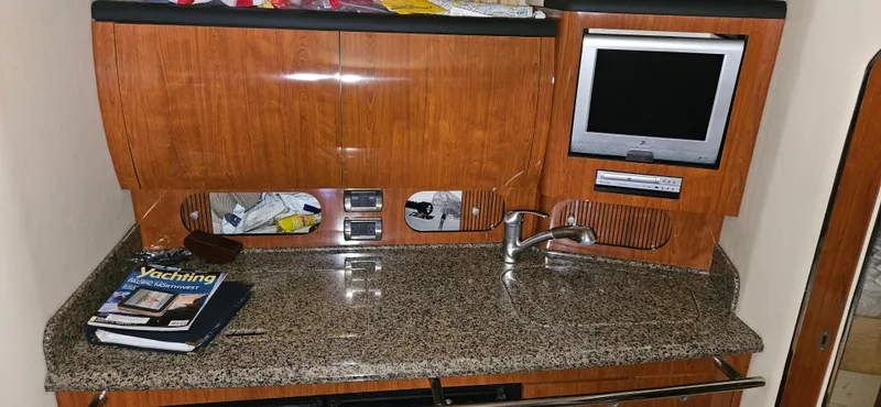 Slide: The Image of 2005 Sea Ray 360 Sundancer interior with granite countertop, sink, and built-in TV. - 13
