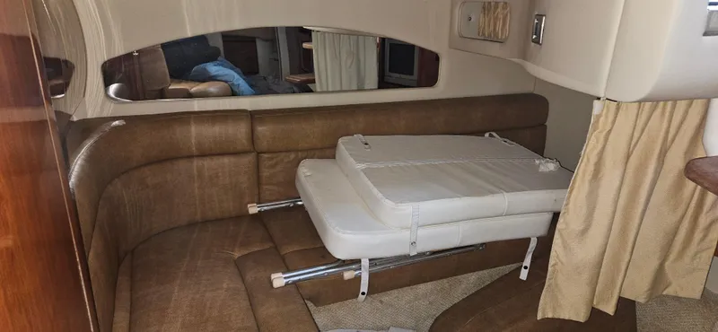 Slide: The Image of 2005 Sea Ray 360 Sundancer interior with brown leather seating and foldable table. - 17