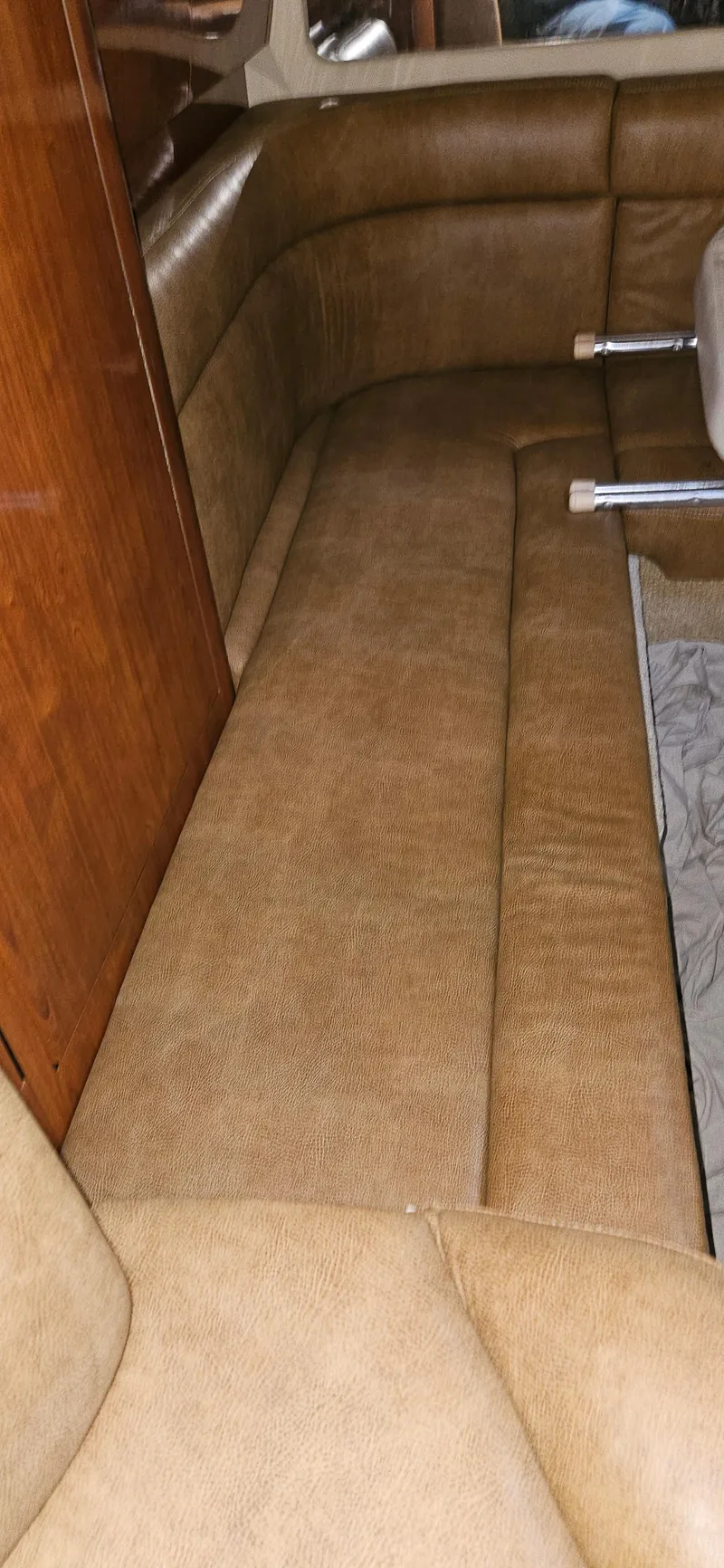 Slide: The Image of 2005 Sea Ray 360 Sundancer interior with tan leather seating and wooden accents. - 18