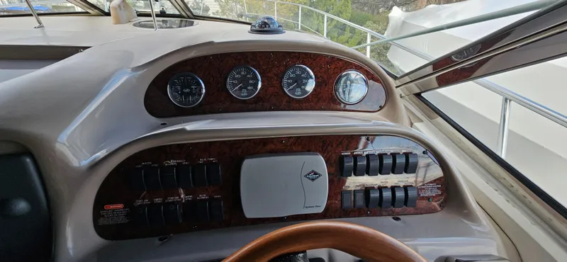 Slide: The Image of Dashboard of a 2005 Sea Ray 360 Sundancer boat with gauges and controls. - 20