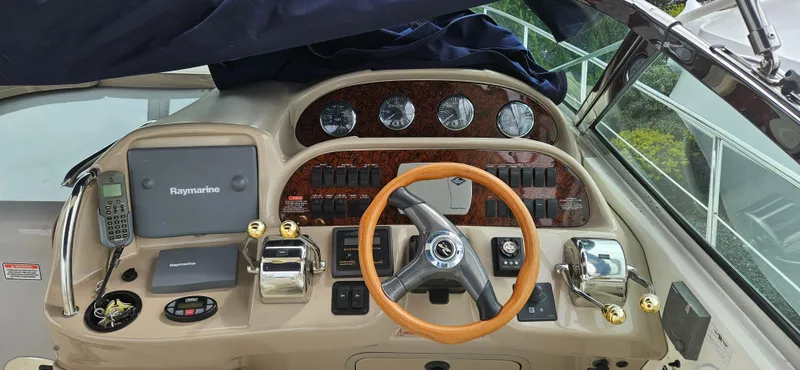 Slide: The Image of Cockpit of 2005 Sea Ray 360 Sundancer with steering wheel and navigation controls. - 3