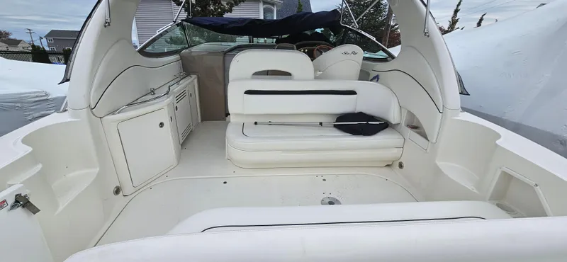 Slide: The Image of 2005 Sea Ray 360 Sundancer boat interior with white seating and helm. - 4