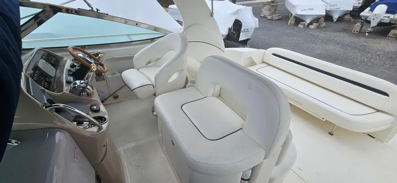 Slide: The Image of 2005 Sea Ray 360 Sundancer cockpit with white seating and steering wheel. - 5