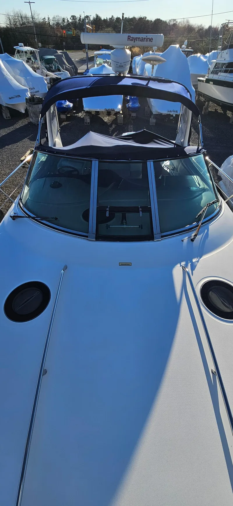 Slide: The Image of 2005 Sea Ray 360 Sundancer boat, docked, with Raymarine equipment visible. - 6