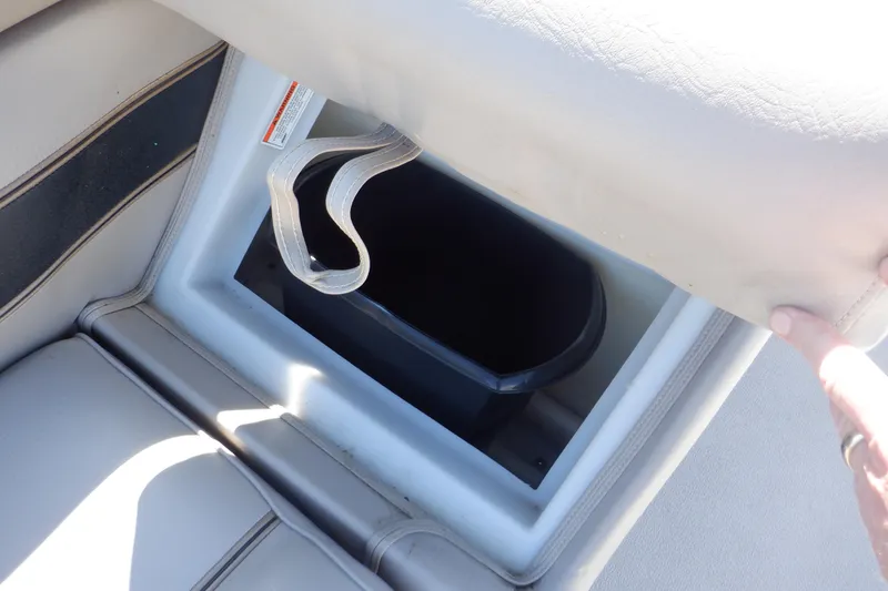 Slide: The Image of 2009 Premier 225 Sunsation LTD boat seat storage compartment with strap, open view. - 19