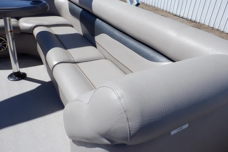 Slide: The Image of Luxurious seating on 2009 Premier 225 Sunsation LTD pontoon boat, featuring plush gray upholstery. - 21