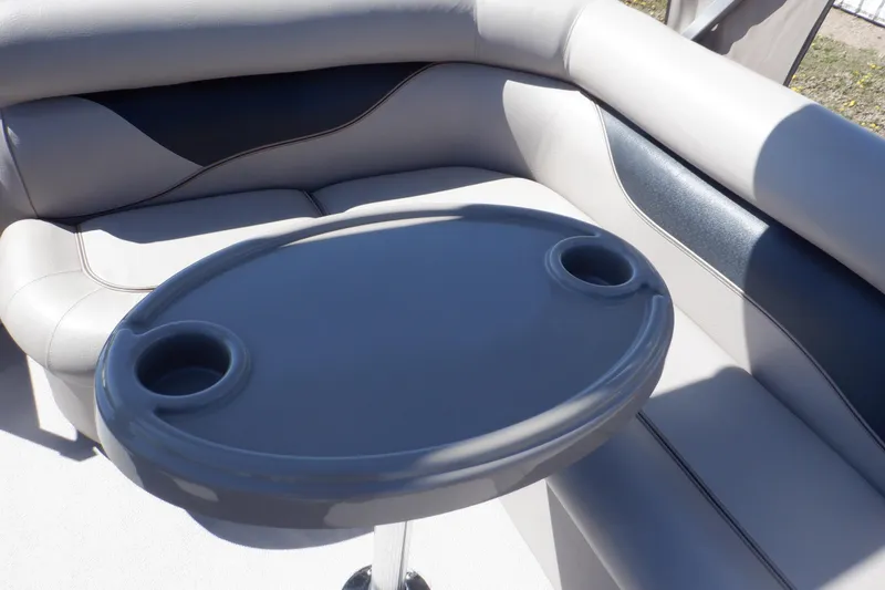 Slide: The Image of 2009 Premier 225 Sunsation LTD boat interior with cushioned seating and oval table. - 22