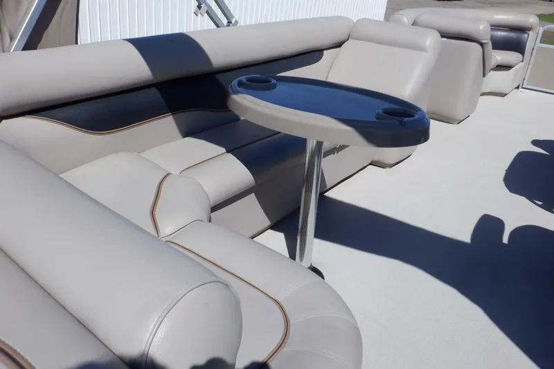 Slide: The Image of 2009 Premier 225 Sunsation LTD boat interior with beige seating and a small table. - 25