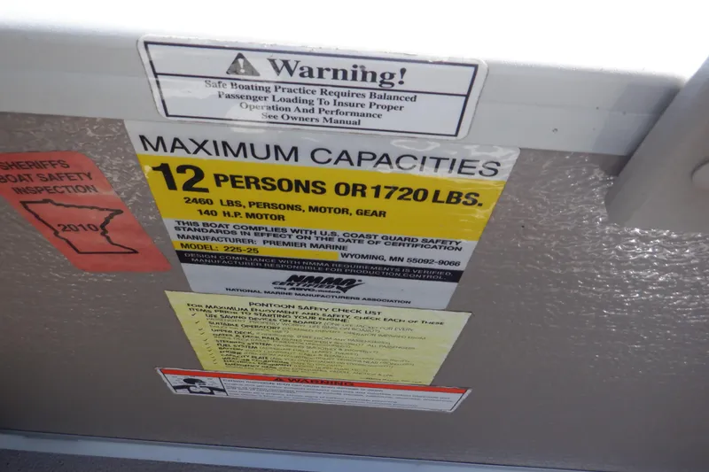 Slide: The Image of Warning label on 2009 Premier 225 Sunsation LTD showing maximum capacity of 12 persons or 1720 lbs. - 28