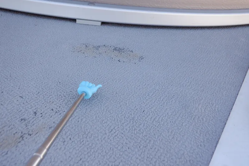 Slide: The Image of 2009 Premier 225 Sunsation LTD boat deck with cleaning tool on textured surface. - 44