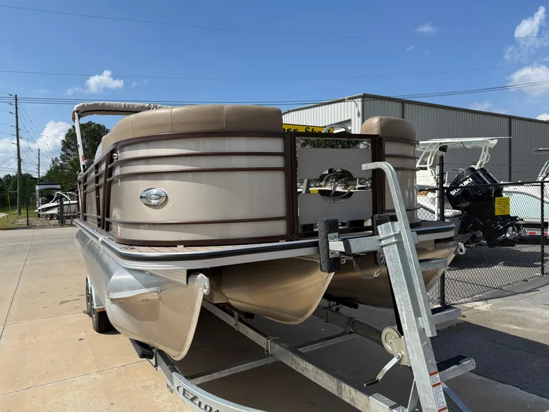 Slide: The Image of 2023 Veranda VTX 22RC pontoon boat on trailer, parked outdoors under clear blue sky. - 13