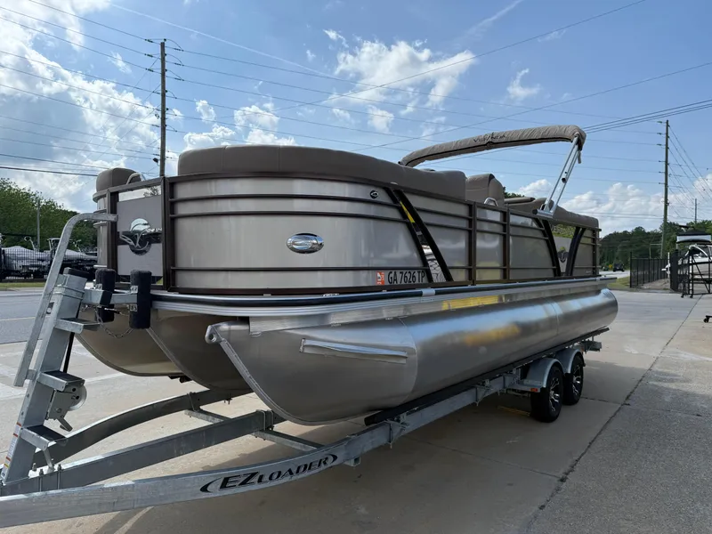 Slide: The Image of 2023 Veranda VTX 22RC pontoon boat on trailer, parked outdoors. - 22