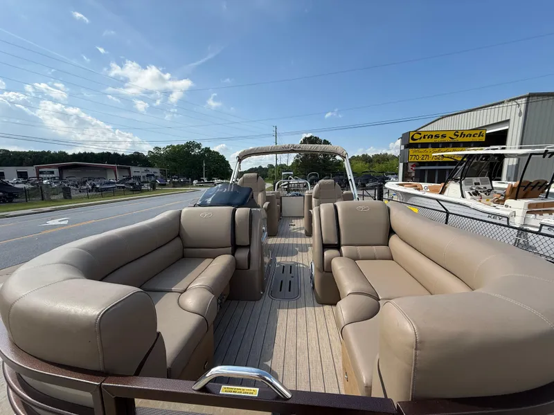 Slide: The Image of 2023 Veranda VTX 22RC pontoon boat with spacious seating, parked outdoors. - 26