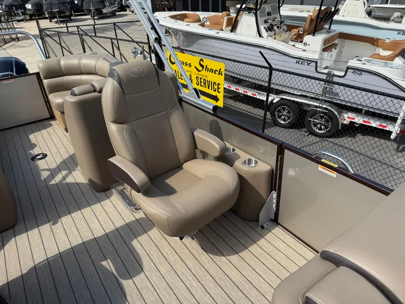Slide: The Image of 2023 Veranda VTX 22RC boat interior with beige seating and cup holders. - 32